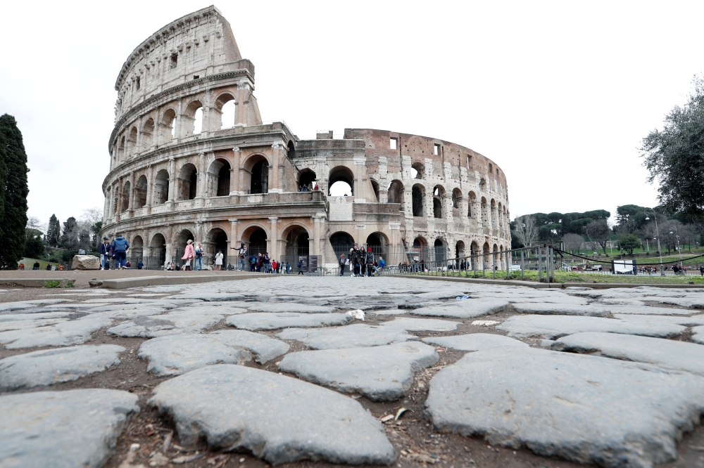 Very few people are seen in the area surrounding the Colosseum, which would usually be full of tourists, in Rome, Italy, March 2, 2020. Reuters/Remo Casilli
 