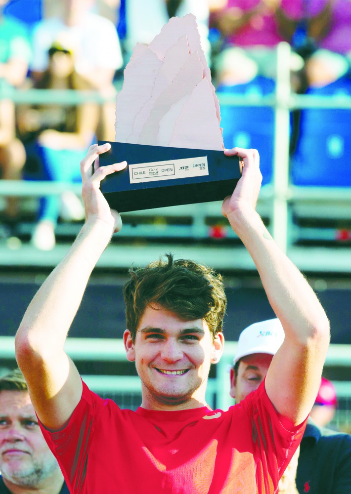 Brazil's Thiago Seyboth Wild holds the trophy after after winning the ATP World Tour Santiago Open 2020 final match against Norway's Casper Ruud in Santiago, on March 1, 2020.  AFP / Claudio Reyes
