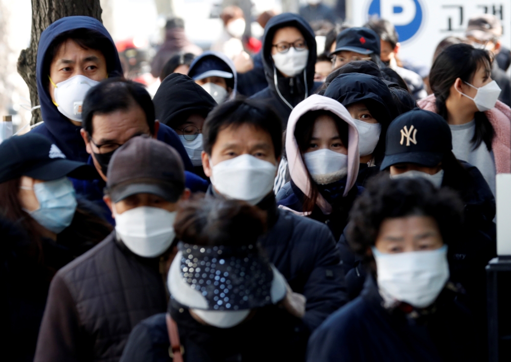 People stand in a long queue to buy face masks at a post office, after a shortage of masks amid the rise in confirmed cases of the novel coronavirus disease COVID-19, in Daegu, South Korea, March 4, 2020. REUTERS/Kim Kyung-Hoon