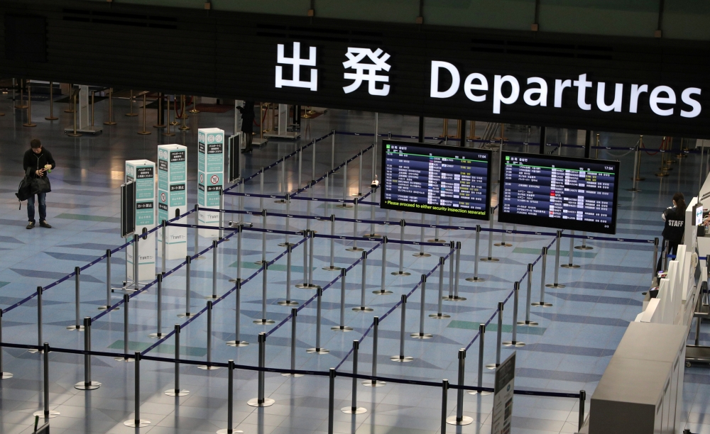An empty departures gate is pictured at Haneda Airport in Tokyo, Japan, March 4, 2020. REUTERS/Stoyan Nenov