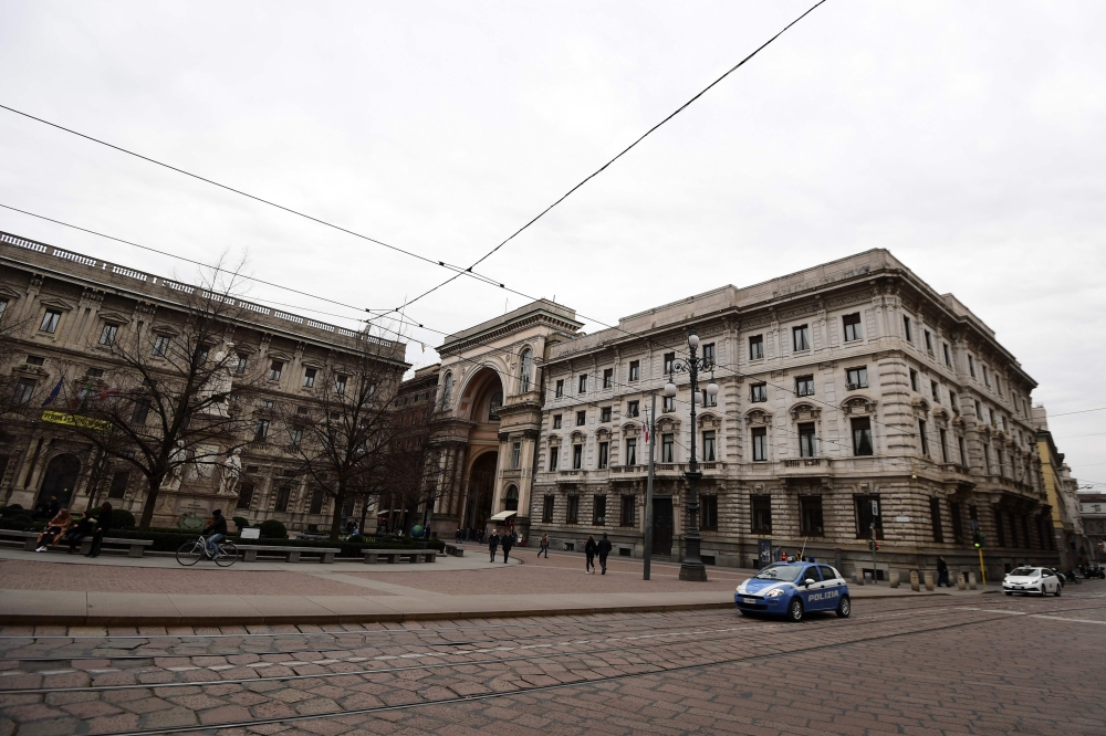 An Italian police car is seen near a mainly deserted Piazza della Scala on February 29, 2020 in center Milan, northern Italy.  AFP / Miguel Medina
 
