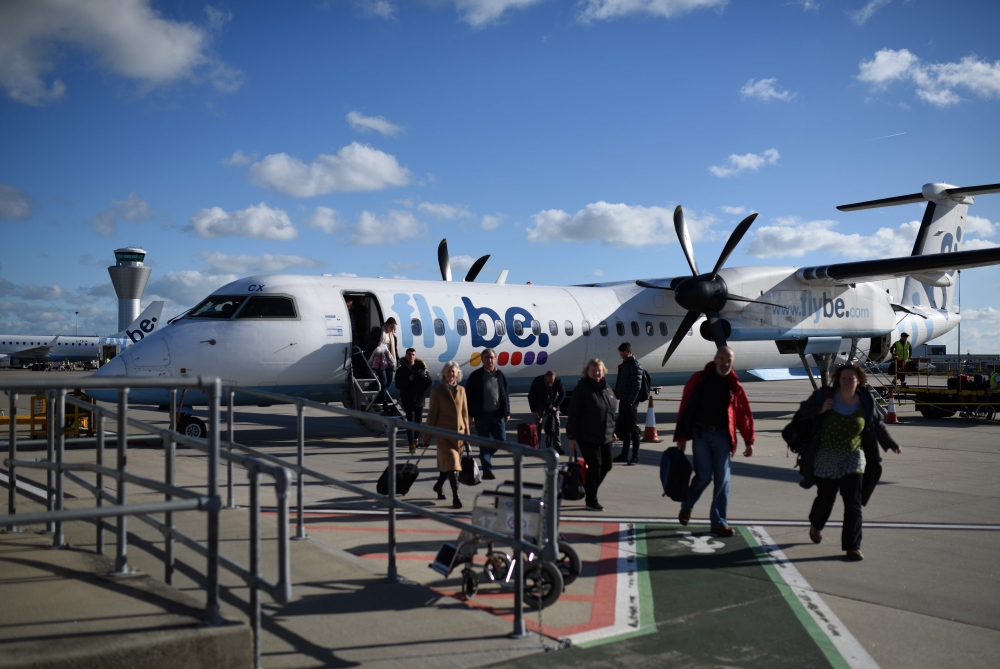 In this file photo taken on November 08, 2017 Passengers dissembark from a FlyBE aircraft after landing at Jersey Airport in St Peter, north of St Helier, on the British island of Jersey. AFP / Oli Scarff
 
