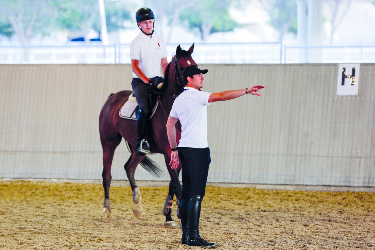 Belgian rider Nicola Philippaerts (right) offers tips to a young rider during the Internations Camp at Al Shaqab, on Tuesday.
