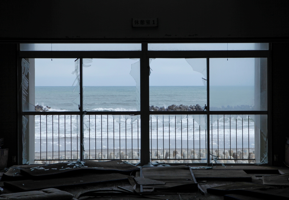  The ocean is seen through broken windows of a building which was damaged by the March 11, 2011 earthquake and tsunami in Futaba Town, near tsunami-crippled Fukushima Daiichi nuclear power plant, Fukushima Prefecture, Japan February 17, 2020. Picture take