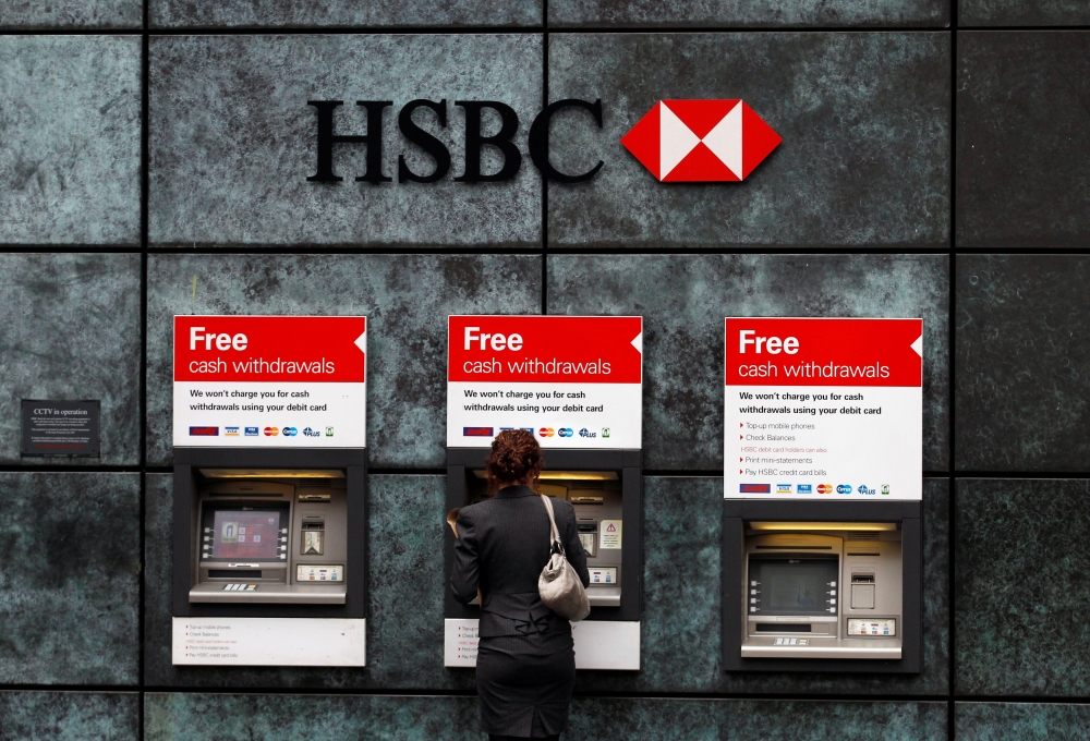 A woman uses a cash point machine at a HSBC bank in the City of London in a file photo. Reuters / Andrew Winning