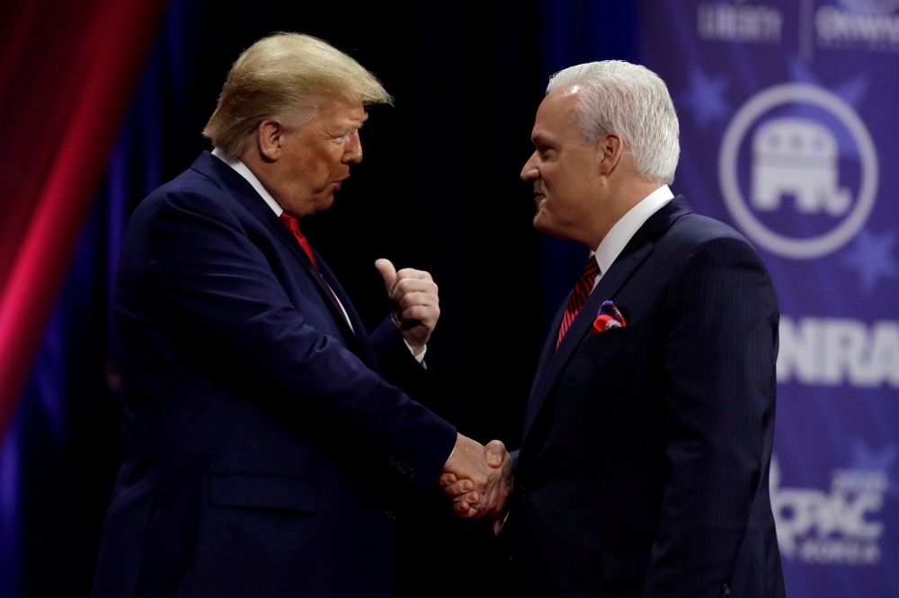FILE PHOTO: U.S. President Donald Trump (L) shakes hands with Matt Schlapp, chairman of the American Conservative Union, at the Conservative Political Action Conference (CPAC) annual meeting at National Harbor in Oxon Hill, Maryland, U.S., February 29, 20