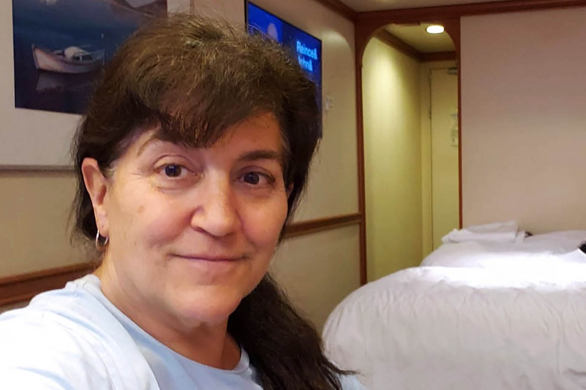 This handout photo released by Carolyn Wright, a passenger on the Grand Princess cruise ship, shows her taking a selfie in her cabin on the ship on March 7, 2020. AFP PHOTO / CAROLYN WRIGHT 