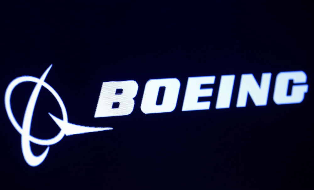 FILE PHOTO: The company logo for Boeing is displayed on a screen on the floor of the New York Stock Exchange (NYSE) in New York, U.S., March 11, 2019. REUTERS/Brendan McDermid
