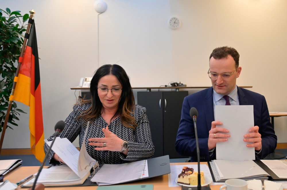German Health Minister Jens Spahn and Berlin's Health Senator Dilek Kalayci prepare for a meeting with the federal Health Minsters in Berlin on March 4, 2020, to discuss measures in connection with the novel coronavirus. / AFP / Tobias SCHWARZ