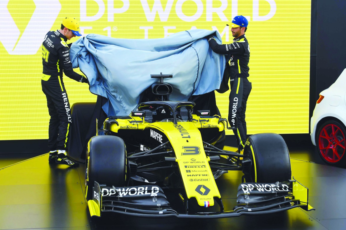 Renault's Australian driver Daniel Ricciardo (R) and Renault's French driver Esteban Ocon (L) unveil the team's new car at the Albert Park circuit ahead of the Formula One Australian Grand Prix in Melbourne on March 11, 2020. AFP / William West