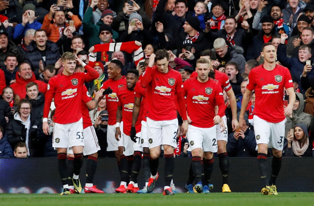 Soccer Football - Premier League - Manchester United v Manchester City - Old Trafford, Manchester, Britain - March 8, 2020 Manchester United's Anthony Martial celebrates scoring their first goal with teammates REUTERS/Phil Noble 