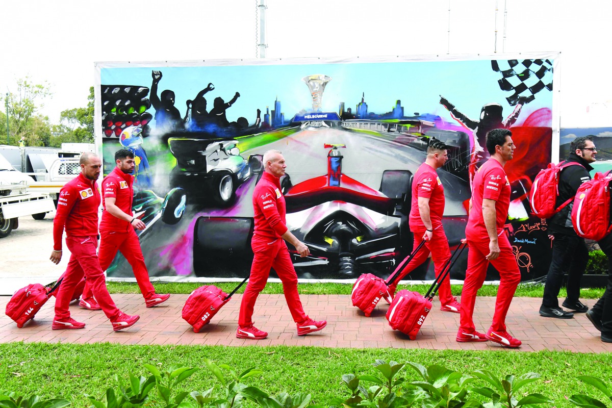 Members of the Ferrari team arrive to pack up their equipment after the Formula One Australian Grand Prix was cancelled in Melbourne on March 13, 2020. AFP / William West 