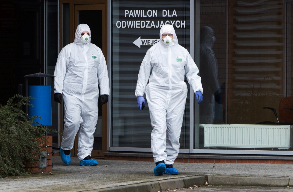 Medical staff in protective gear walk at the infectious ward of the Multidisciplinary City Hospital of Jozef Strus in Poznan, Poland March 12, 2020. Lukasz Cynalewski/Agencja Gazeta/via REUTERS