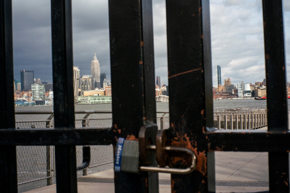 The Empire State Building and New York skyline are seen while a public park is shuttered due to the outbreak of coronavirus disease (COVID-19), in Hoboken, New Jersey, U.S., March 16, 2020. REUTERS/Eduardo Munoz