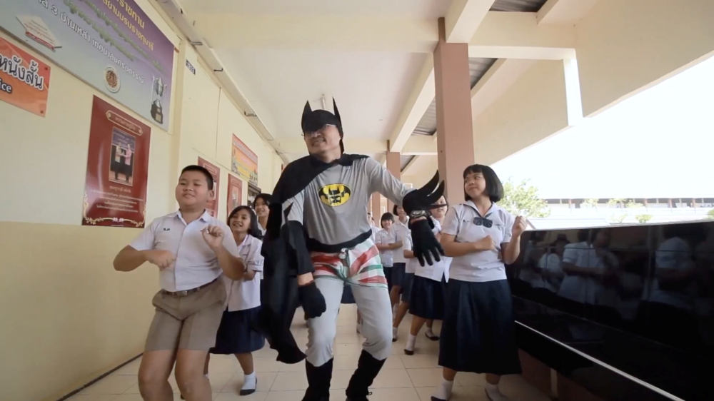 Thai teacher Worrawut Lakchai dressed as a batman sings and dances in fight against coronavirus disease (COVID-19) in Udon Thani province, Thailand in this screen grab obtained by Reuters from social media undated video, on March 18, 2020. YOUTUBE/HUGIDEA