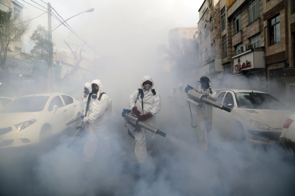 TEHRAN, IRAN - MARCH 19: Fire brigade crews wearing protective masks carry out disinfection works due to the coronavirus (COVID-19) outbreak, on March 19, 2020 in Tehran, Iran. The death toll in Iran from the coronavirus outbreak rose to 1284. ( Fatemeh B