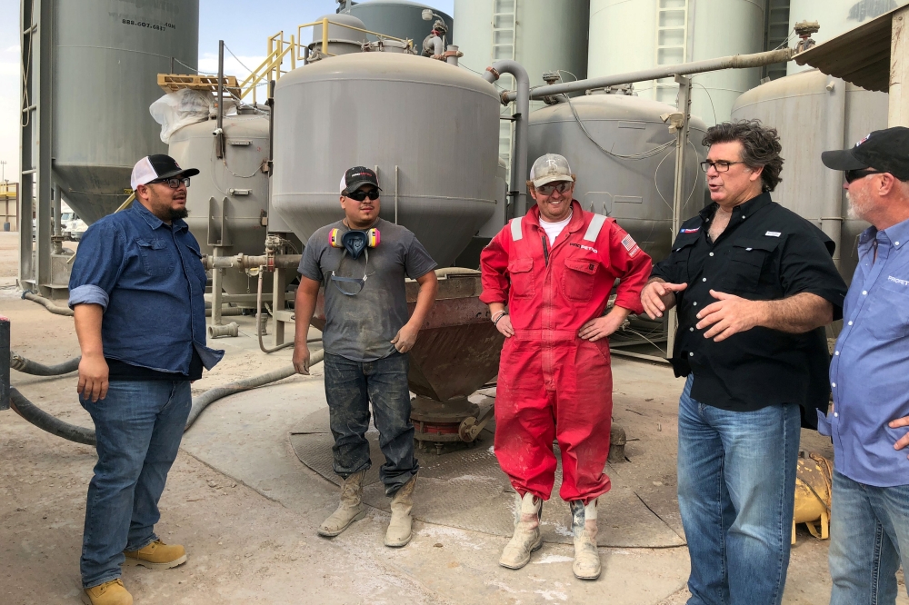 Dale Redman, CEO of ProPetro, speaks with workers on a yard where he stores and manages equipment for his Midland fracking services company in Midland, Texas, on April 12, 2018. Reuters/Ann Saphir
 
  