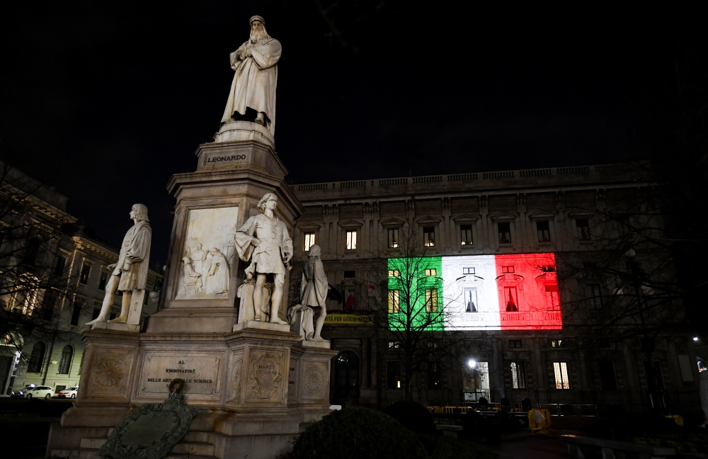 The Palazzo Marino building is seen iluminated with the colours of the Italian flag as the spread of coronavirus disease (COVID-19) continues, in Milan, Italy March 20, 2020. REUTERS/Daniele Mascolo
