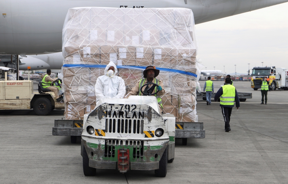 Ethiopian Airlines workers transport a consignment of medical donation from Chinese billionaire Jack Ma and Alibaba Foundation to Africa for coronavirus disease (COVID-19) testing, upon arrival at the Bole International Airport in Addis Ababa, Ethiopia Ma
