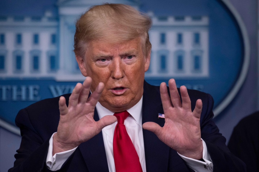 US President Donald Trump gestures as he speaks during the daily briefing on the novel coronavirus, COVID-19, at the White House on March 22, 2020, in Washington, DC. AFP / Eric Baradat
 