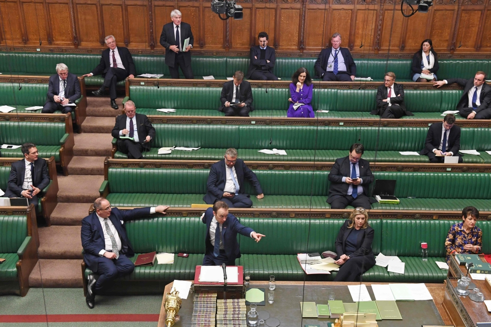 A handout photograph released by the UK Parliament shows Britain's Health Secretary Matt Hancock standing at the dispatch box and speaking during the Coronavirus Bill debate to socially distanced MPs in the House of Commons in London on March 23, 2020.  A