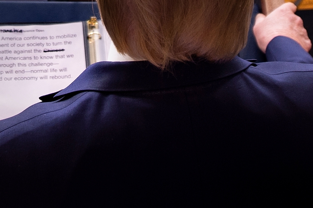 S President Donald Trump looks at his notes showing the word 