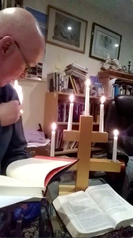 Vicar Stephen Beach of St Budeaux parish church reacts as his sweater catches fire while delivering a video sermon, amid the coronavirus disease (COVID-19) outbreak, in Plymouth, Britain, March 19, 2020, in this still image from video obtained via social 