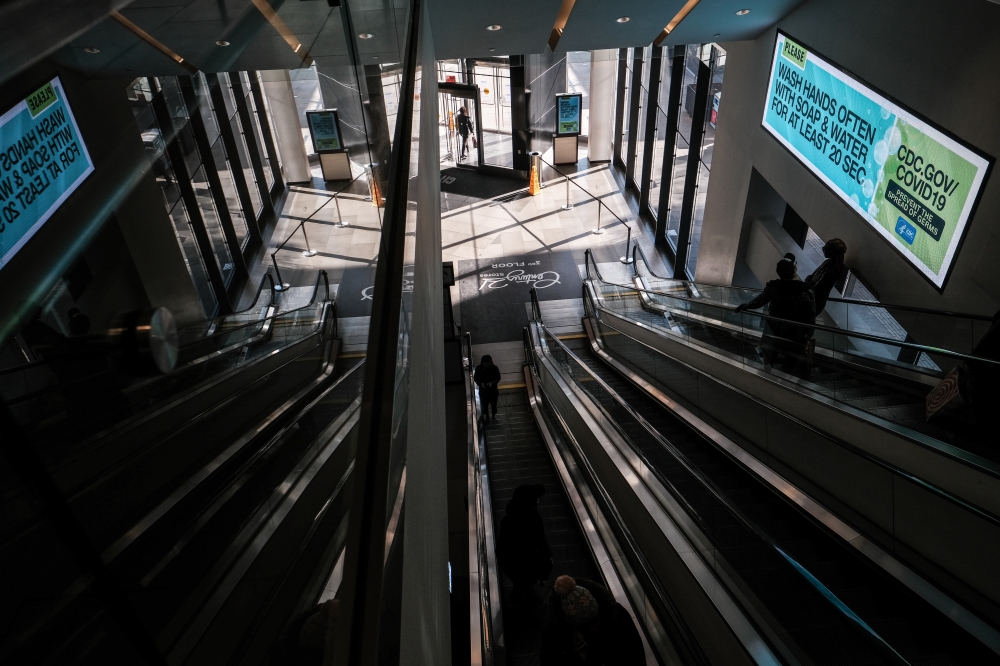 A screen in City Point mall warns against the outbreak of the coronavirus disease (COVID-19) in the Brooklyn borough of New York City, U.S., March 26, 2020. REUTERS/Stephen Yang