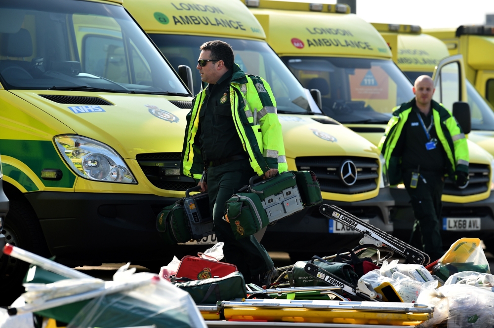 Staff prepare to load equipment into London Ambulance Service vehicles in the east car park at the ExCeL London exhibition centre in London on March 28, 2020. AFP / Glyn KIRK