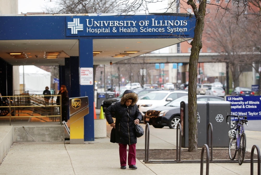 A woman walks outside the University of Illinois Hospital. REUTERS/Joshua Lott