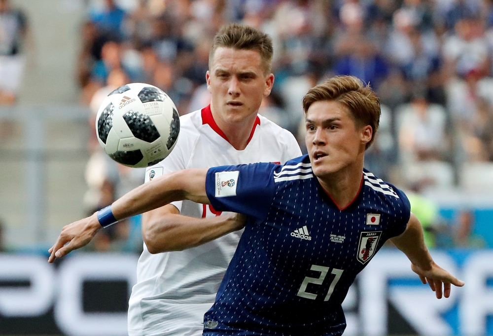 FILE PHOTO: Soccer Football - World Cup - Group H - Japan vs Poland - Volgograd Arena, Volgograd, Russia - June 28, 2018 Japan's Gotoku Sakai in action with Poland's Piotr Zielinski REUTERS/Jorge Silva/File Photo