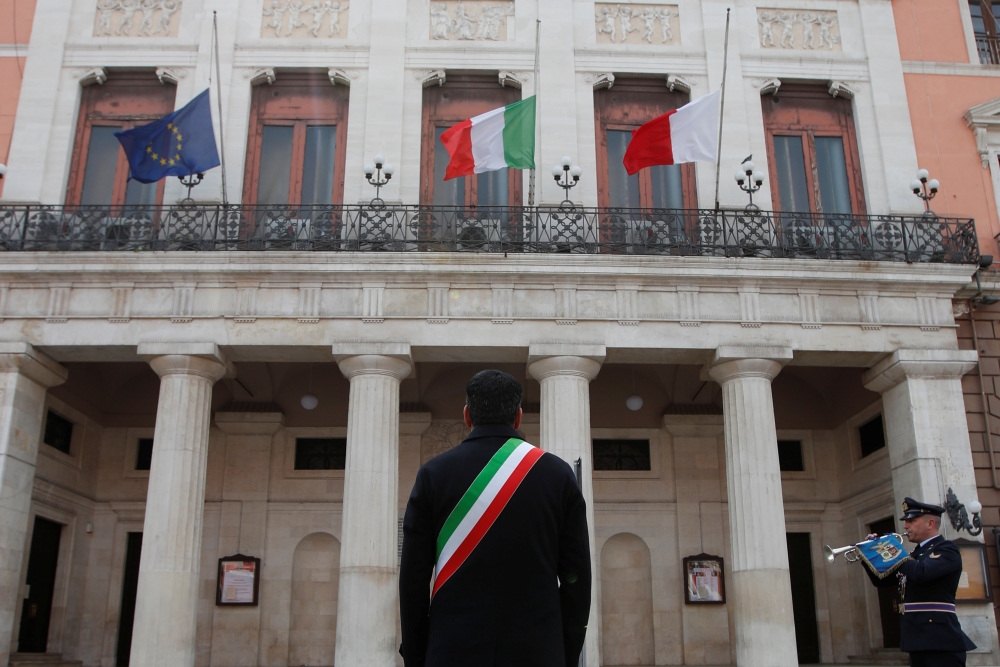 Mayor of Bari Antonio Decaro attends a ceremony to draw an Italian flag to half mast as mayors across Italy stand in silence to honour the country's dead due to coronavirus disease (COVID-19), in Bari, Italy, March 31, 2020. REUTERS/Alessandro Garofalo