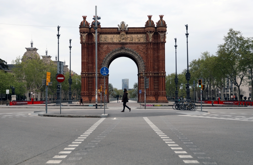 People walk near Arc de Triomf during the outbreak of the coronavirus disease (COVID-19), in Barcelona, Spain, March 31, 2020. REUTERS/Nacho Doce

