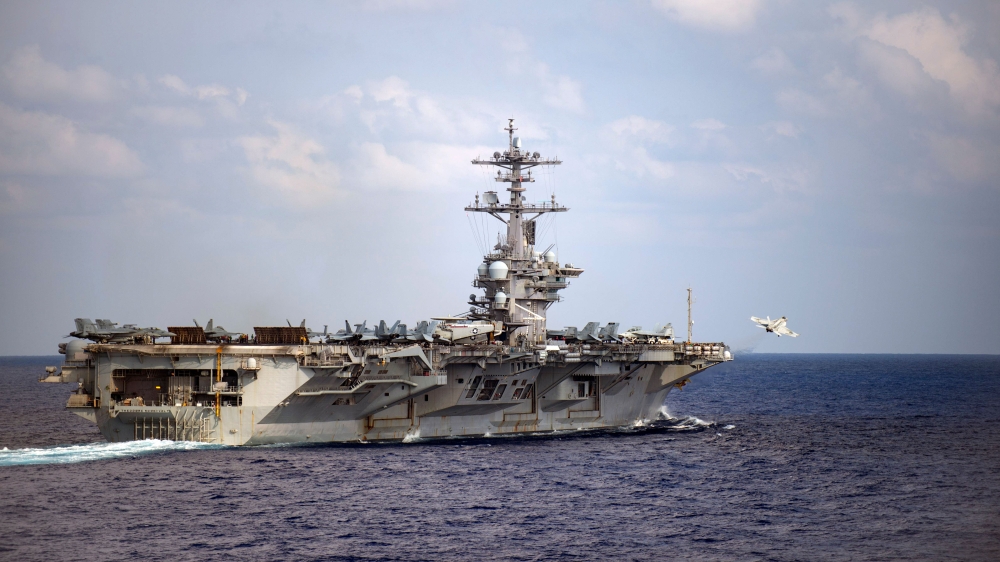 In this file US Navy handout photo obtained March 31, 2020 shows an F/A-18F Super Hornet, assigned to the “Black Knights” of Strike Fighter Squadron (VFA) 154, launching from the flight deck of the aircraft carrier USS Theodore Roosevelt (CVN 71), on Marc