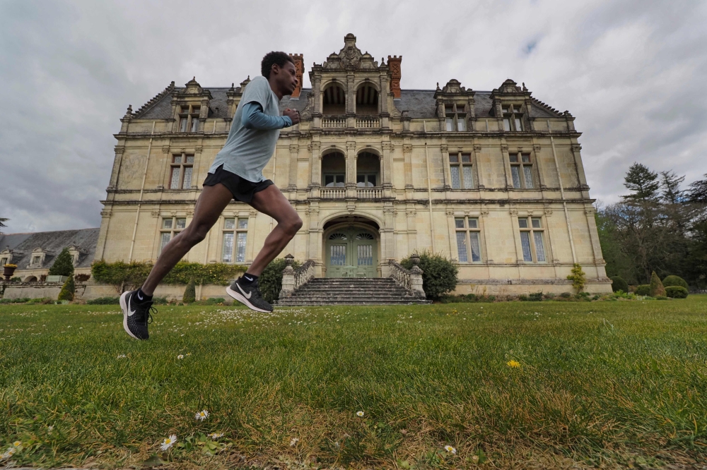 TOPSHOT - French half marathon runner Yosi Goasdoue trains in the park of the Castle of La Bourdaisiere, where he is staying during a strict lockdown in France aimed at curbing the spread of COVID-19 (novel coronavirus), on April 3, 2020, in Montlouis-sur