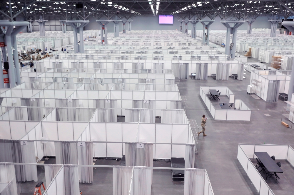 A member of the U.S. Army walks among cubicles being prepared in phase 2 of the Javits new york medical Station at the Jacob K. Javits Convention Center during the coronavirus disease (COVID-19) outbreak in Manhattan, New York City, U.S., April 3, 2020. R