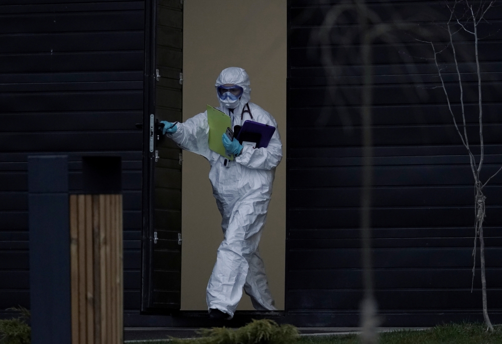 A medical specialist wearing protective gear walks out of a hospital for patients infected with the coronavirus disease (COVID-19) on the outskirts of Moscow, Russia April 14, 2020. REUTERS/Tatyana Makeyeva