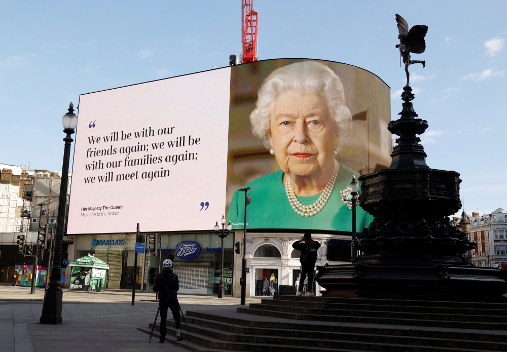A message from Britain's Queen Elizabeth II is displayed on a screen in Piccadilly Circus, as the spread of the coronavirus disease (COVID-19) continues, London, Britain, April 19, 2020. REUTERS/John Sibley
