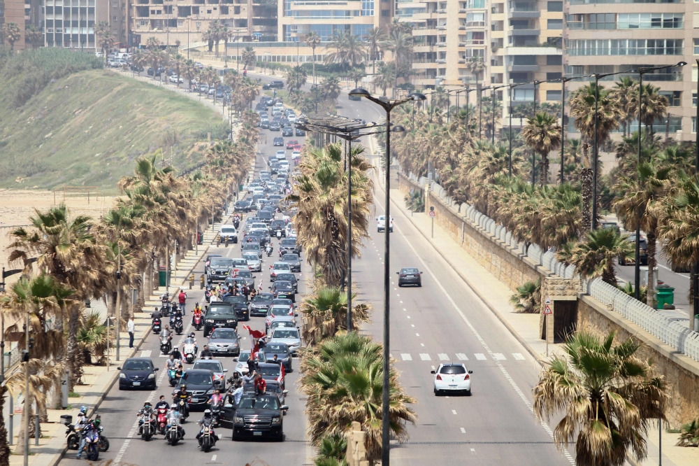 Dozens of Lebanese protesters defy a stay-at-home order to protest in their cars deteriorating living conditions and maintain pressure on a political elite under fire since mass protests erupted last October, in the capital Beirut on April 21, 2020. AFP /