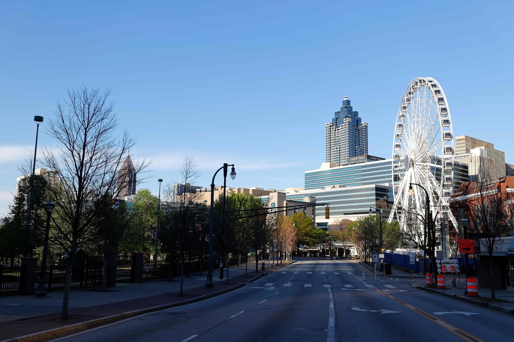 (FILES) This file photo taken on April 4, 2020 shows a view of an empty Centennial Olympic Park Drive NW in Atlanta, Georgia, amid the novel coronavirus pandemic.  / AFP / NORTH AMERICA / Kevin C. Cox