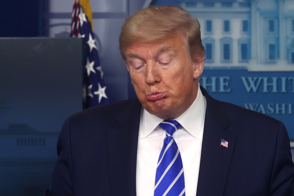 U.S. President Donald Trump reacts as he leads the daily coronavirus disease (COVID-19) outbreak task force briefing at the White House in Washington, U.S. April 23, 2020. REUTERS/Jonathan Ernst