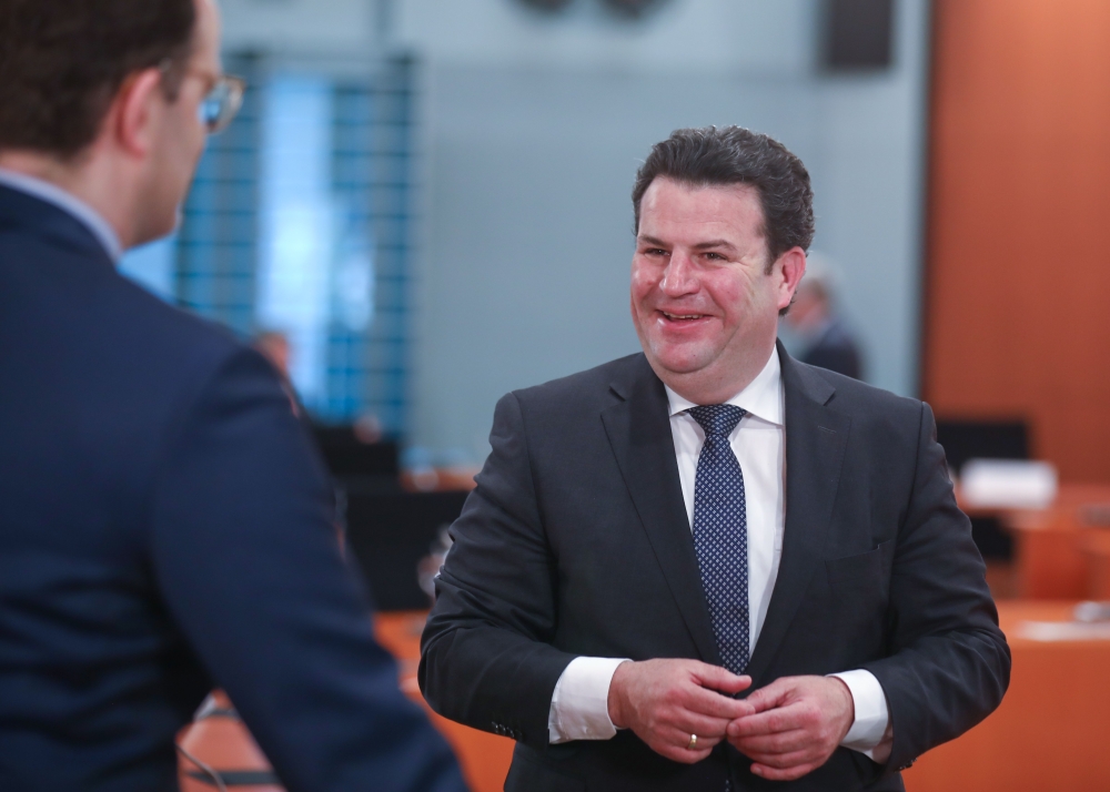 German Labour Minister Hubertus Heil (R) talks with German Health Minister Jens Spahn prior to the weekly cabinet meeting on April 22, 2020 at the Chancelery in Berlin, as the spread of the new coronavirus that can cause the COVID-19 disease continues. / 