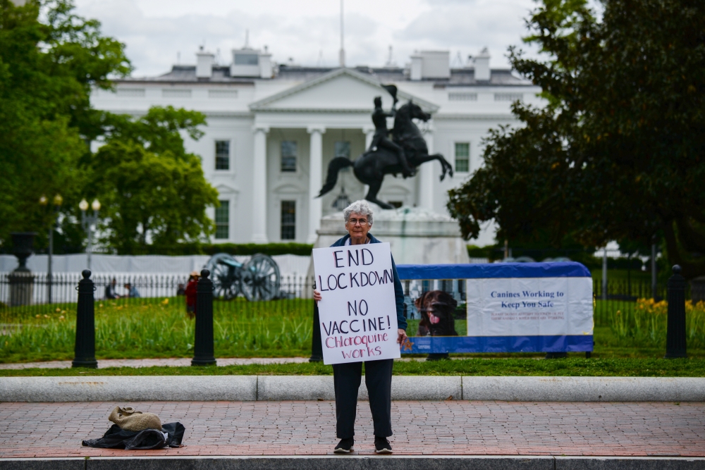 Kathy Boylan protests business closings, amid the spread of the coronavirus disease (COVID-19), in front of the White House in Washington, U.S., April 25, 2020. REUTERS/Erin Scott
