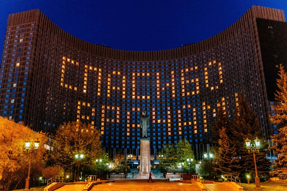 This picture taken on April 29, 2020, shows a view of huge lettering reading “Thanks to Doctors” formed by turned on lights in rooms of Kosmos hotel in Moscow, during a strict lockdown in Russia to stop the spread of the COVID-19 infection caused by the n