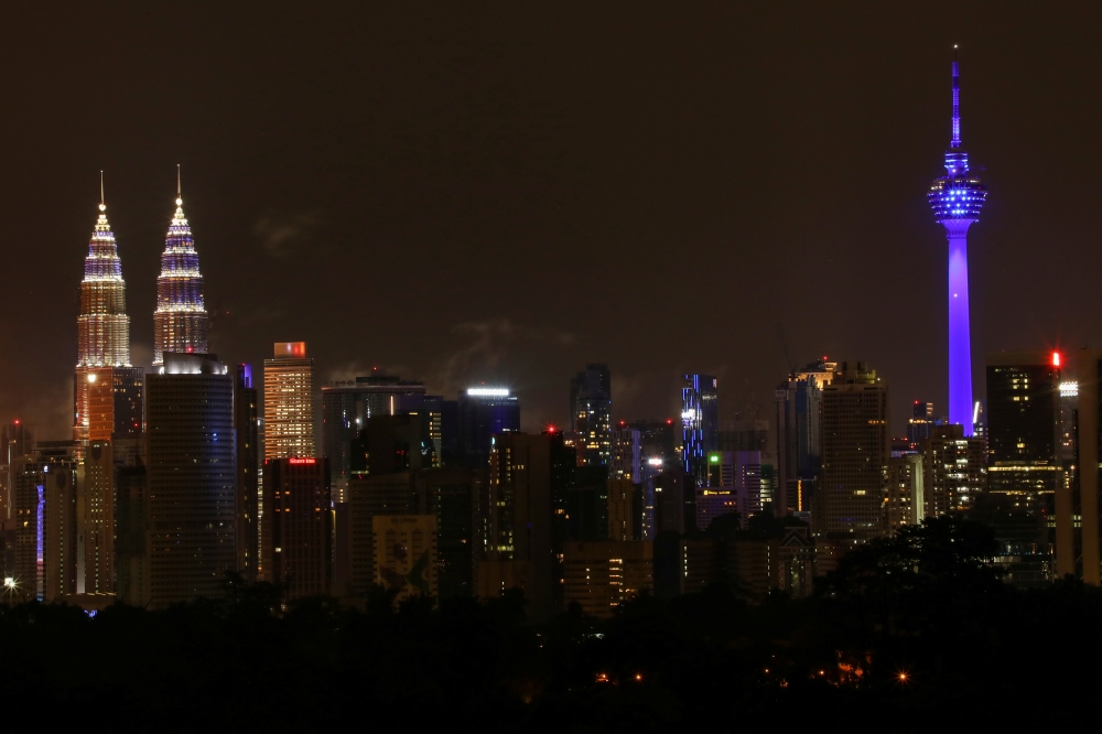 Buildings are seen illuminated in blue as part of the 