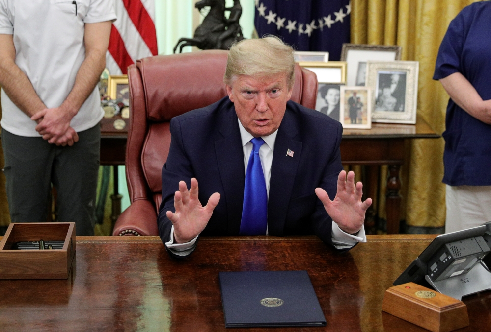 :U.S. President Donald Trump speaks before signing a proclamation in honor of National Nurses Day in the Oval Office at the White House in Washington, U.S., May 6, 2020. REUTERS/Tom Brenner
