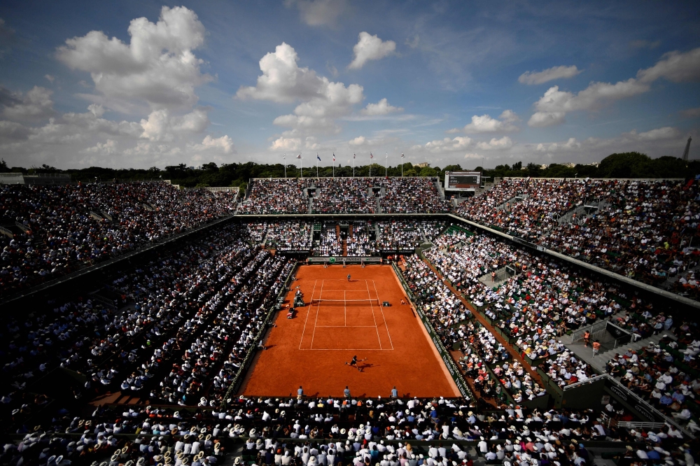 (FILES) In this file photo taken on June 8, 2018 Spectators watch Spain's Rafael Nadal (TOP) as he plays Argentina's Juan Martin del Potro during their men's singles semi-final match on day thirteen of The Roland Garros 2018 French Open tennis tournament 