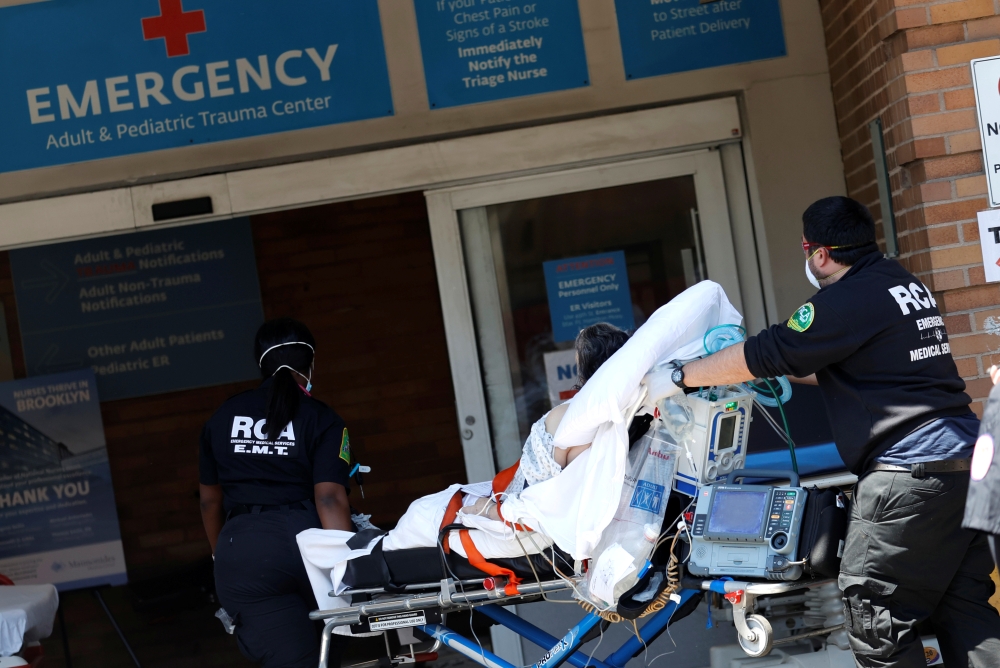 Paramedics wheel a patient into the emergency entrance outside Maimonides Medical Center in Brooklyn during the outbreak of the coronavirus disease (COVID-19) in New York City, New York, U.S., May 13, 2020. REUTERS/Mike Segar
