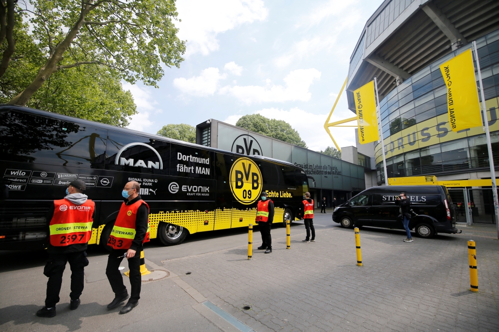 The Borussia Dortmund team coach arrives outside the stadium before the match, following the outbreak of the coronavirus disease (COVID-19) REUTERS/Leon Kuegeler DFL regulations prohibit any use of photographs as image sequences and/or quasi-video