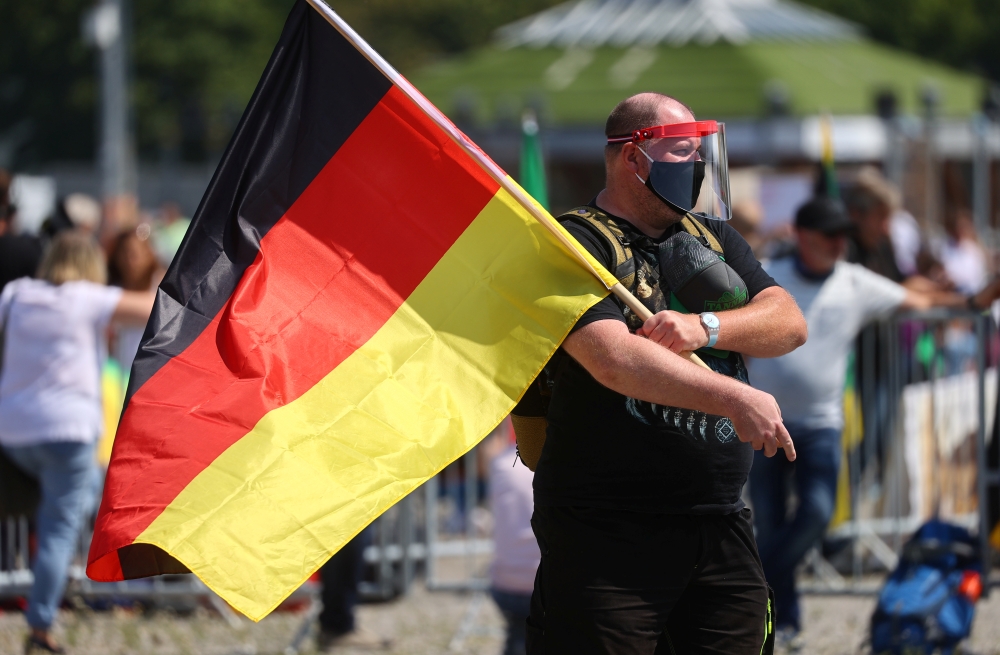 A man wearing a face mask attends a protest against the government's restrictions following the coronavirus disease (COVID-19) outbreak, at Cannstatter Wasen area in Stuttgart, Germany, May 16, 2020. REUTERS/Kai Pfaffenbach